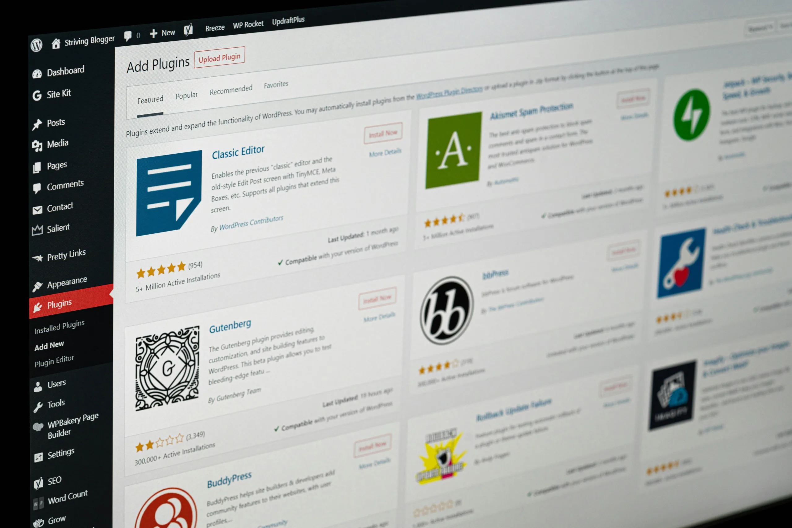 A computer screen displaying the WordPress plugin repository. The interface shows various plugins including 'Classic Editor,' 'Gutenberg,' and 'bbPress.' Each entry includes a title, icon, star rating, and brief description. Great for those looking for a Beginner's Guide to WordPress. The sidebar menu is visible on the left.